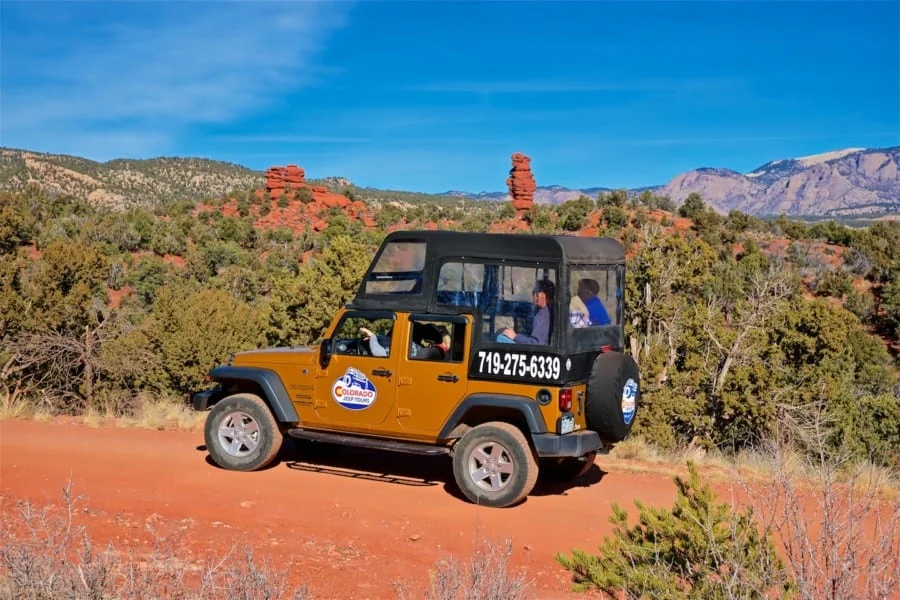 Gold jeep exploring Red Canyon Park