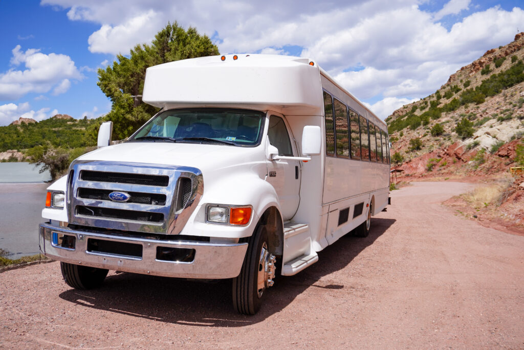 Canon City Transit front of shuttle bus with mountains in background