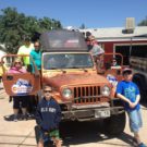 family posing around Jeep during a Colorado Jeep Tour