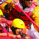 close up of kids getting wet during whitewater rafting tour