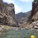 white water rafting with guests going down river