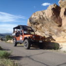 jeep with guests driving down paved road Colorado Jeep Tours