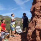 tourists inspecting red rock formations Colorado Jeep Tours
