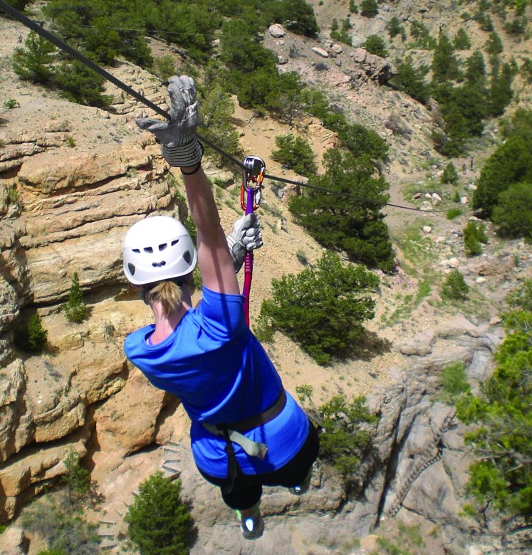 woman does zip line near Royal Gorge in Canon City Colorado